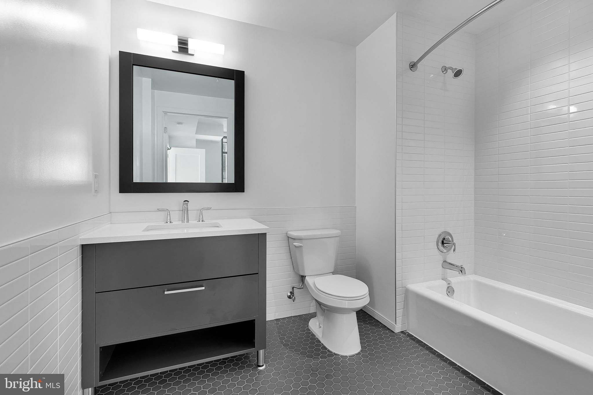 150 I Street Southeast, Unit INTERIOR Washington, DC 20003 - Photo 6 of 21 a bathroom with a toilet sink and mirror