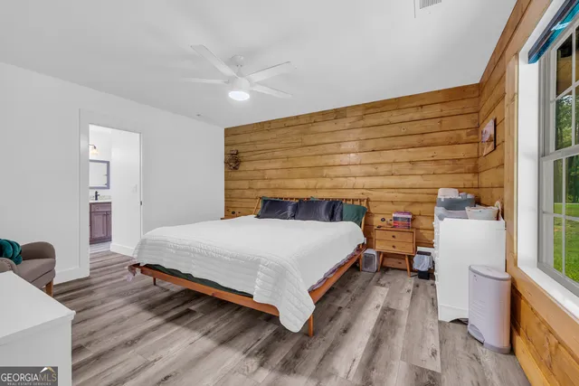 a spacious bedroom with a bed and a dresser