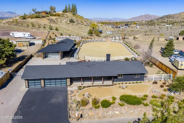 an aerial view of residential houses with outdoor space and seating