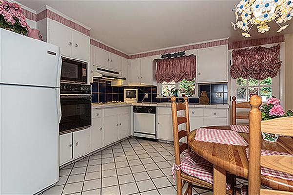 5 Trinity Road Winchester, MA 01890 - Photo 10 of 22 a kitchen with stainless steel appliances granite countertop a stove top oven a sink a counter space and cabinets