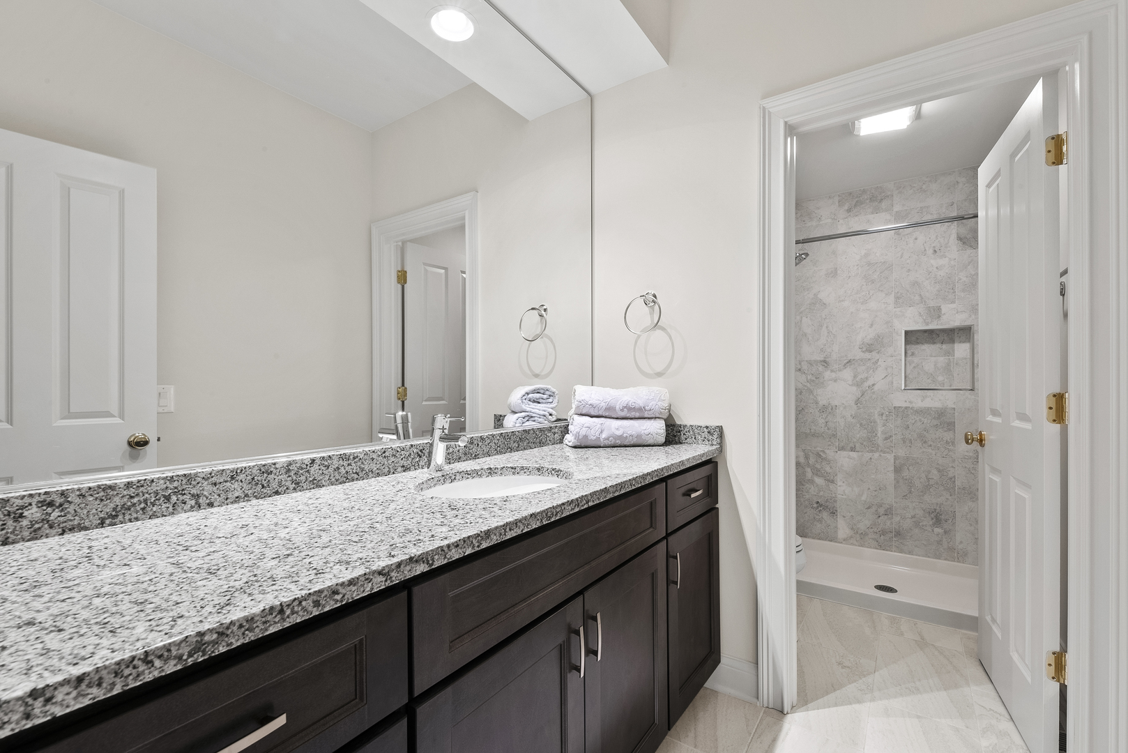 351 Wallace Road Lake Forest, IL 60045 - Photo 15 of 35 a bathroom with a granite countertop sink a mirror and a bathtub