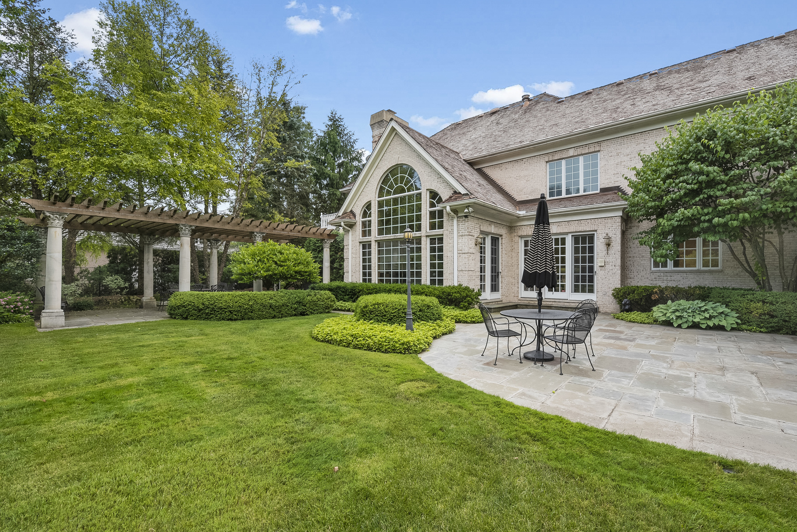 351 Wallace Road Lake Forest, IL 60045 - Photo 26 of 35 a view of a house with a yard and sitting area