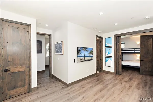 a view of a kitchen with wooden floor and electronic appliances