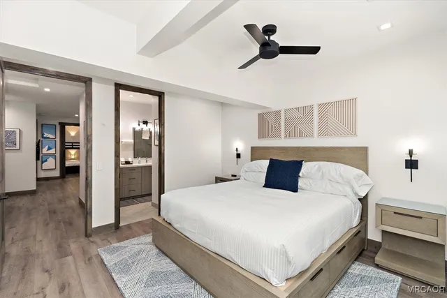 a bedroom with a large bed and ceiling fan