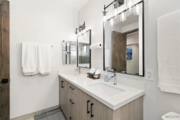 a bathroom with a sink and a mirror