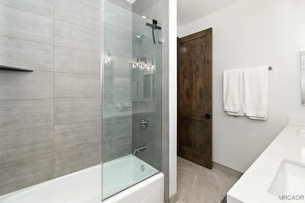 a bathroom with a bathtub and a shower