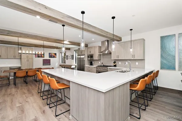 a large kitchen with a table and chairs