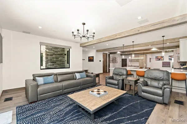 a living room with furniture a rug and a chandelier