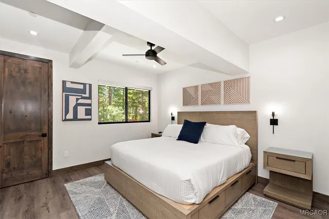 a bedroom with a large bed and a chandelier