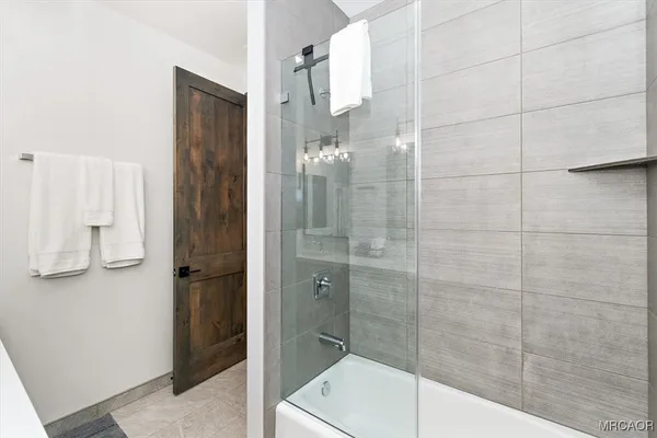 a bathroom with a shower and a sink
