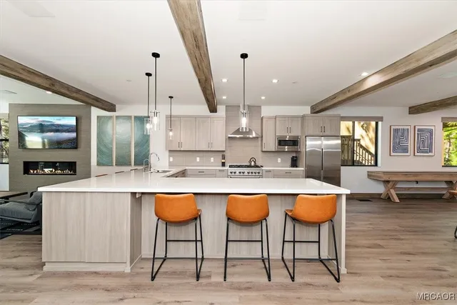 a kitchen with stainless steel appliances granite countertop table chairs sink and cabinets