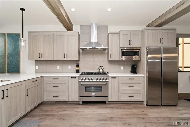 a kitchen with stainless steel appliances white cabinets and a refrigerator