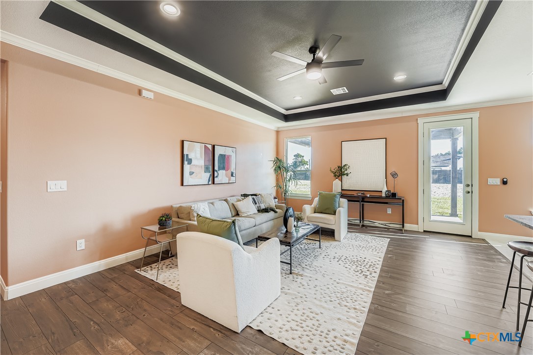 222 Arosa Drive Elgin, TX 78621 - Photo 16 of 40 a living room with furniture and a chandelier