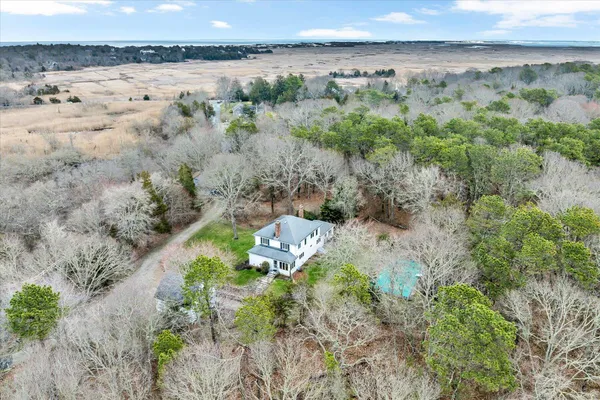 an aerial view of a house with a yard