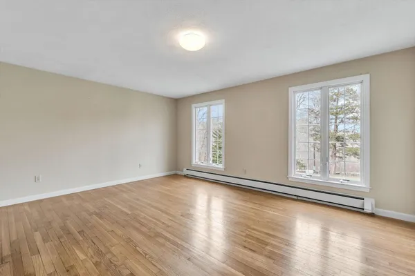a view of an entryway with wooden floor and door