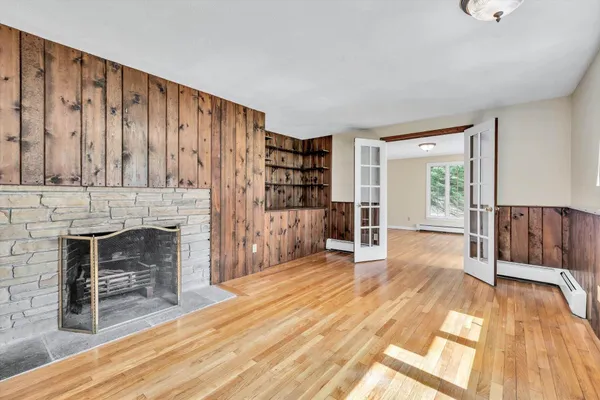 a view of a workspace with furniture and a large window
