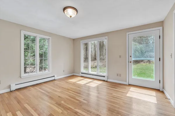 a view of entryway and hall with wooden floor