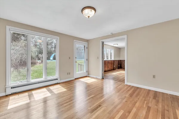 a bedroom with a large bed couch and windows