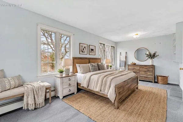 a bedroom with a bed chair and a window