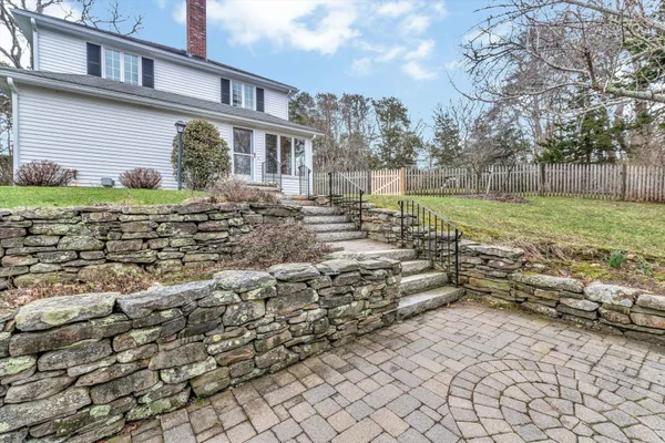 a view of a yard with plants and trees