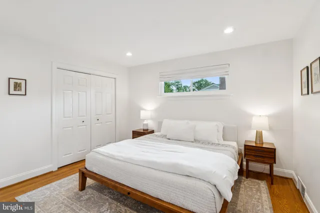 a bedroom with a bed and a desk