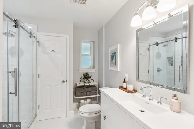a bathroom with a sink toilet and shower