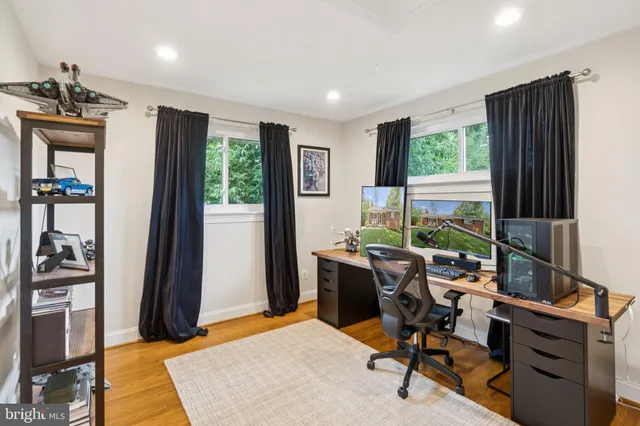 a view of a workspace with furniture and a window