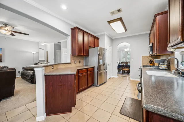 a kitchen with stainless steel appliances granite countertop a sink counter space and cabinets