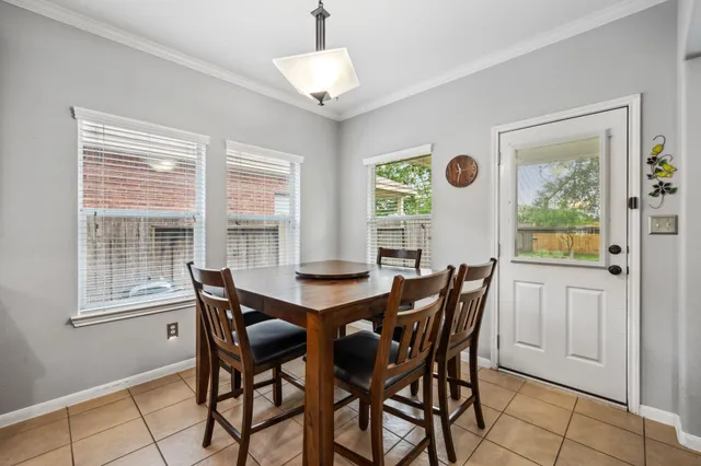 a dining room with furniture and window