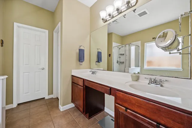 a bathroom with a double vanity sink and a mirror