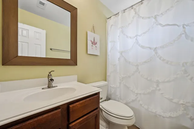 a bathroom with a sink a toilet and a mirror