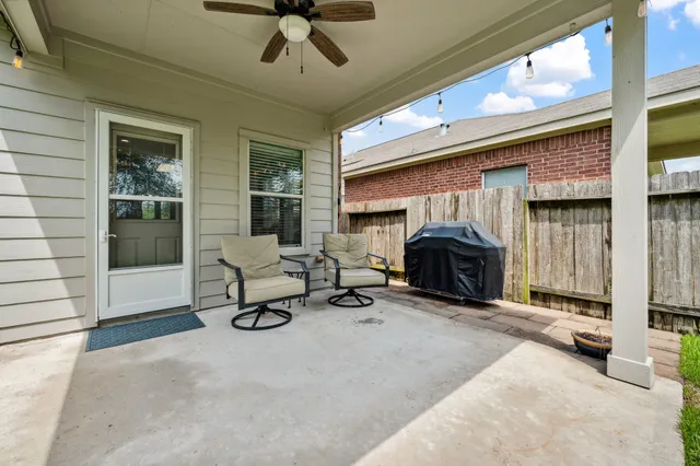a living room with furniture a fireplace and a floor to ceiling window
