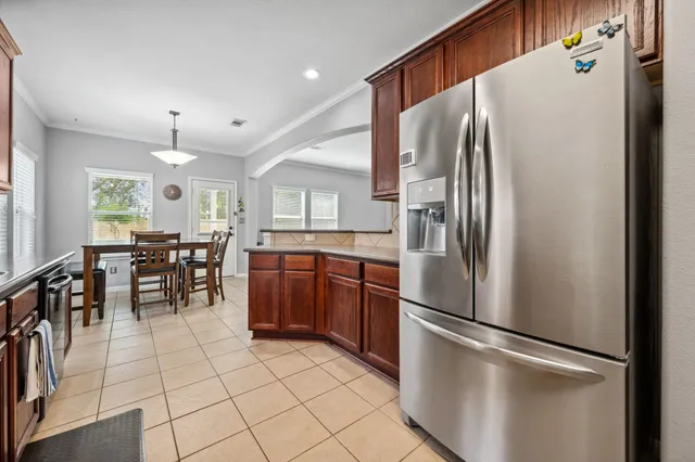 a kitchen with stainless steel appliances granite countertop a refrigerator and a refrigerator