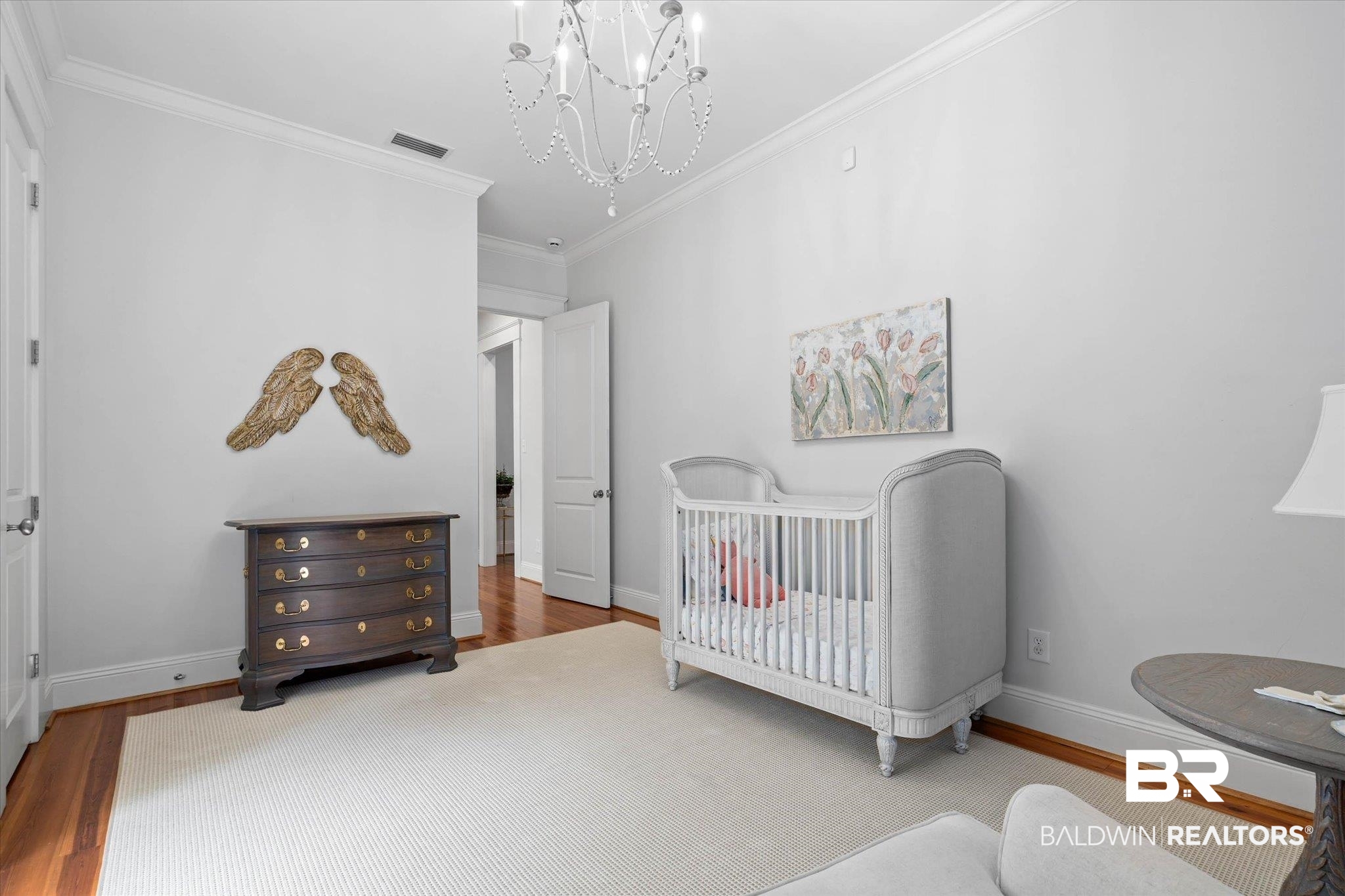 3813 Austill Lane Mobile, AL 36608 - Photo 14 of 37 Hardwood flooring complemented by crown molding and a white ceiling-mounted chandelier