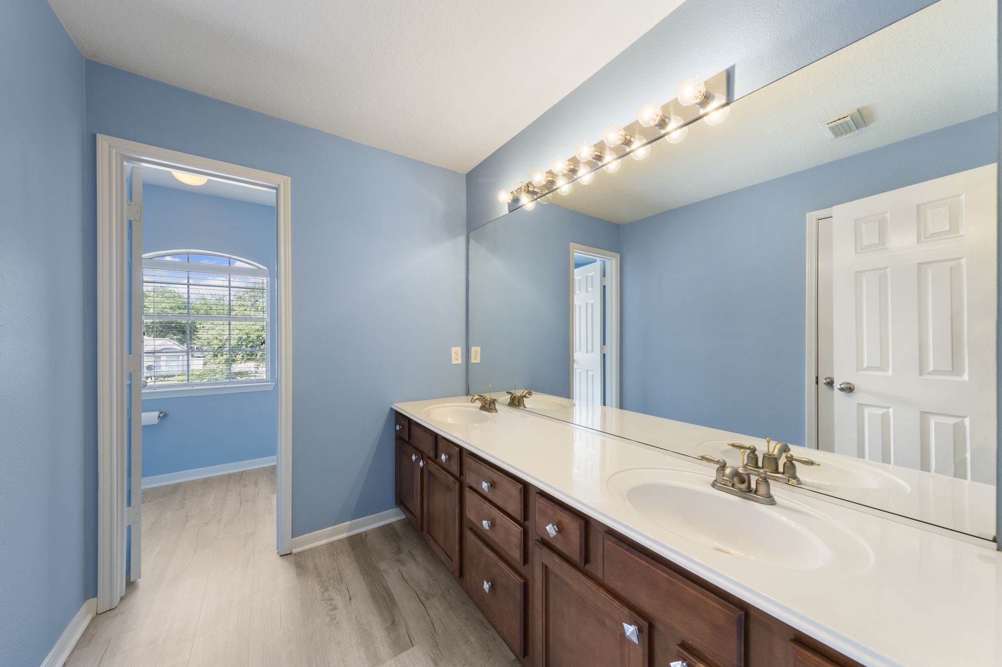 2907 Stemwood Drive Spring, TX 77388 - Photo 23 of 33 Hollywood-style secondary bath featuring an extended dual-sink vanity, abundant storage, and direct access to adjoining bedrooms—designed for both convenience and functionality.