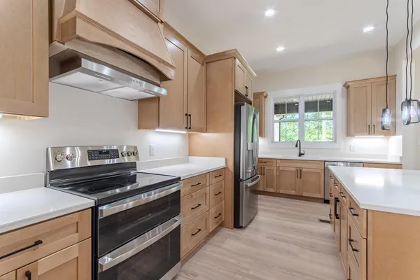 a kitchen with a sink stove and cabinets