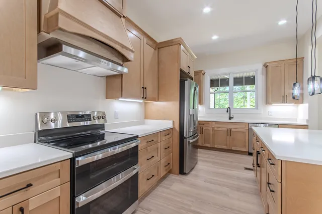 a kitchen with granite countertop a stove and a sink
