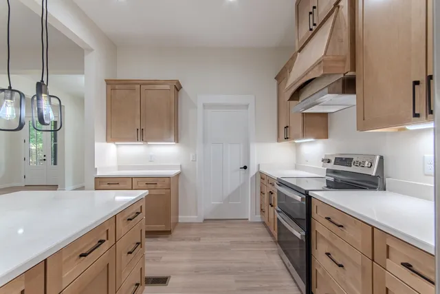 a kitchen with a sink stove and cabinets