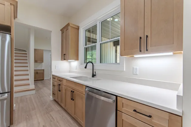 a kitchen with a sink and a window