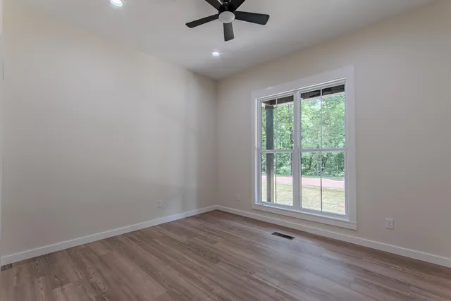 wooden floor in an empty room with a window