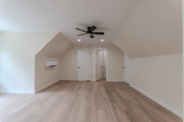 an empty room with a ceiling fan and wooden floor