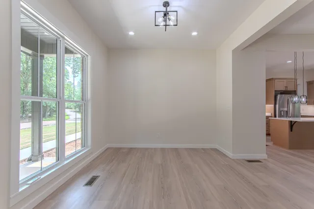 wooden floor in an empty room with a window