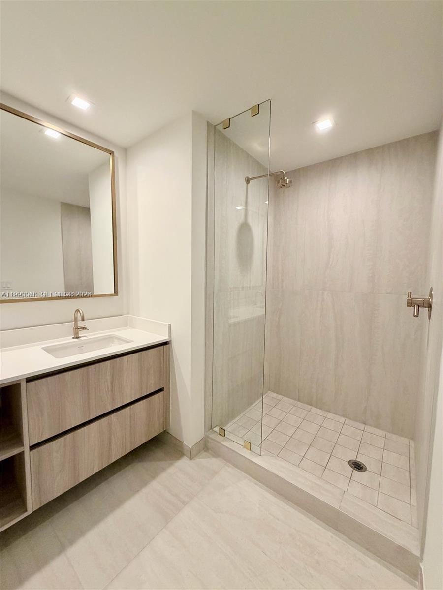 77 Southeast 5th Street, Unit 1608 Miami, FL 33131 - Photo 13 of 44 a bathroom with a double vanity sink mirror and shower
