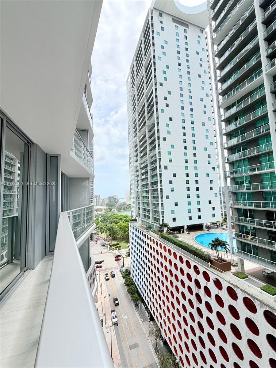 77 Southeast 5th Street, Unit 1608 Miami, FL 33131 - Photo 15 of 44 a view of a balcony with wooden floor