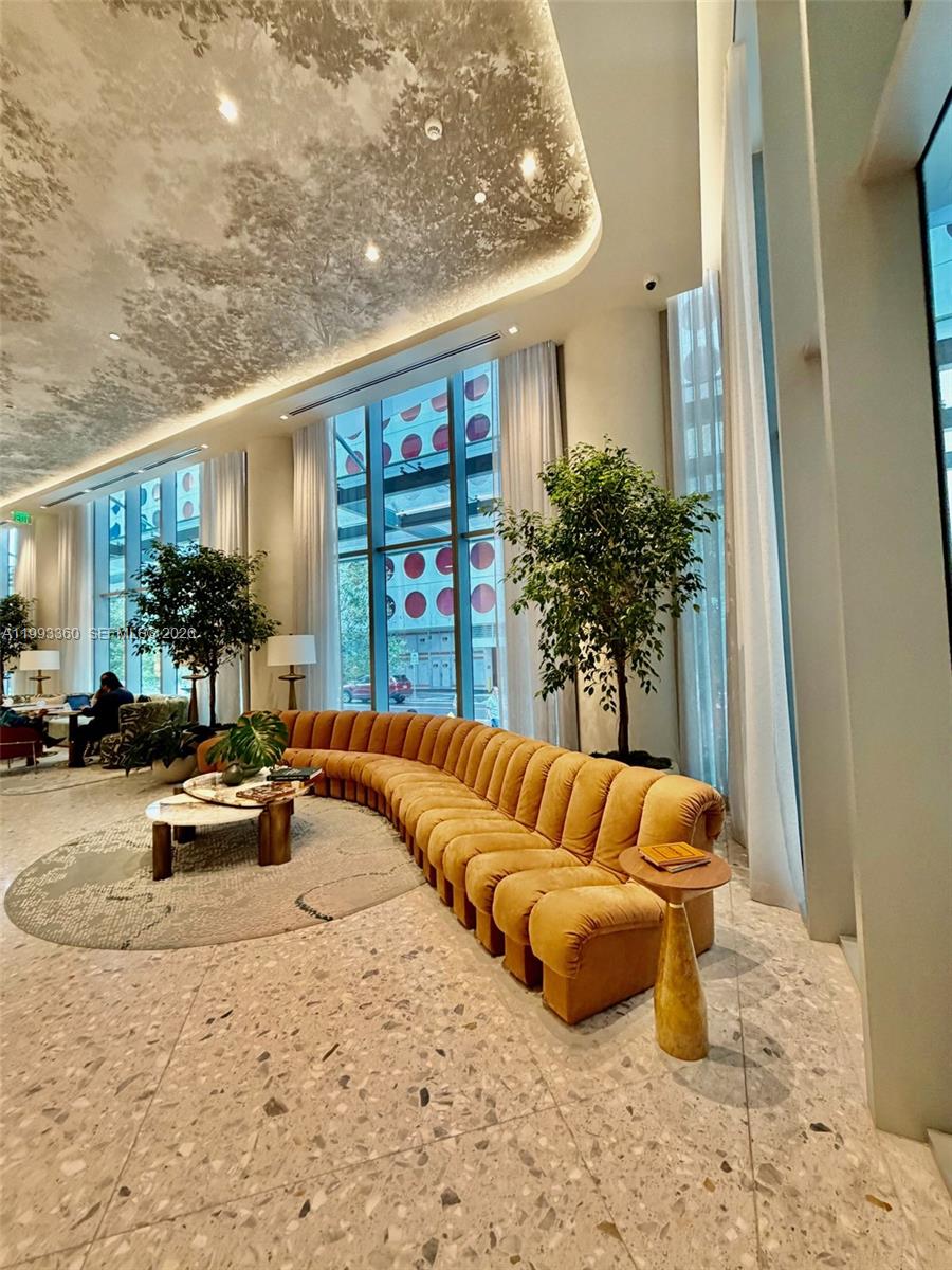 77 Southeast 5th Street, Unit 1608 Miami, FL 33131 - Photo 20 of 44 a view of living room filled with furniture and a potted plant