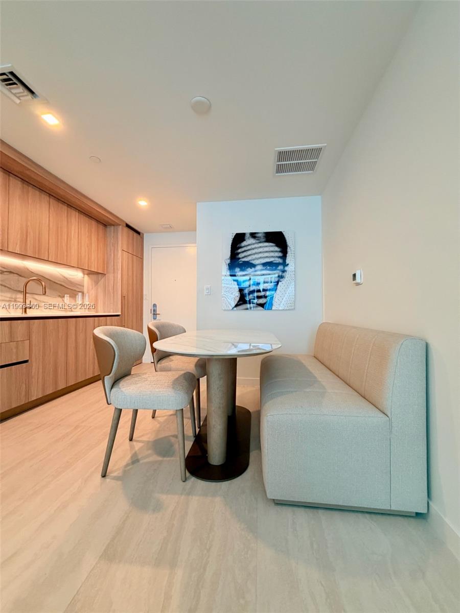 77 Southeast 5th Street, Unit 1608 Miami, FL 33131 - Photo 2 of 44 a living room with furniture and a wooden floor