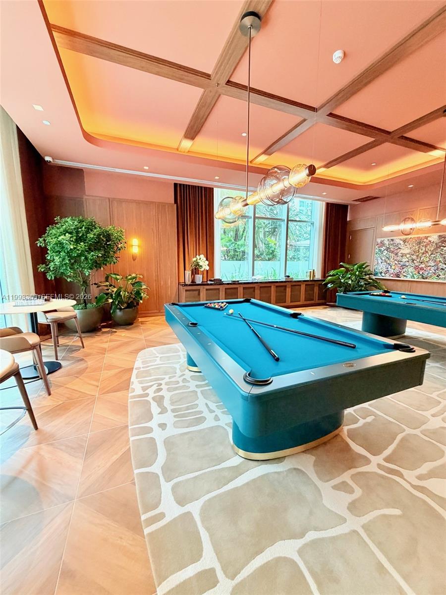 77 Southeast 5th Street, Unit 1608 Miami, FL 33131 - Photo 25 of 44 a view of a patio with a table and chairs under an umbrella