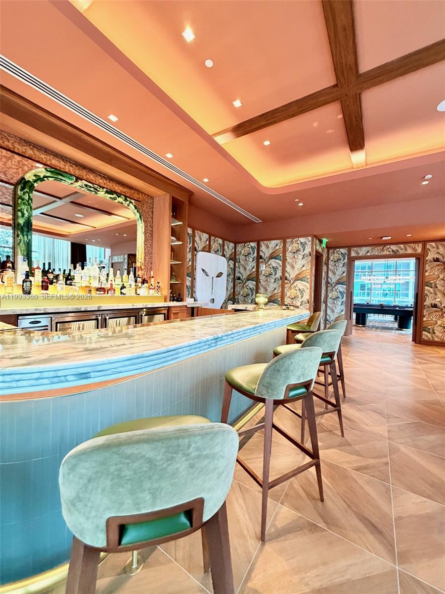 77 Southeast 5th Street, Unit 1608 Miami, FL 33131 - Photo 27 of 44 a dining room with furniture and a floor to ceiling window