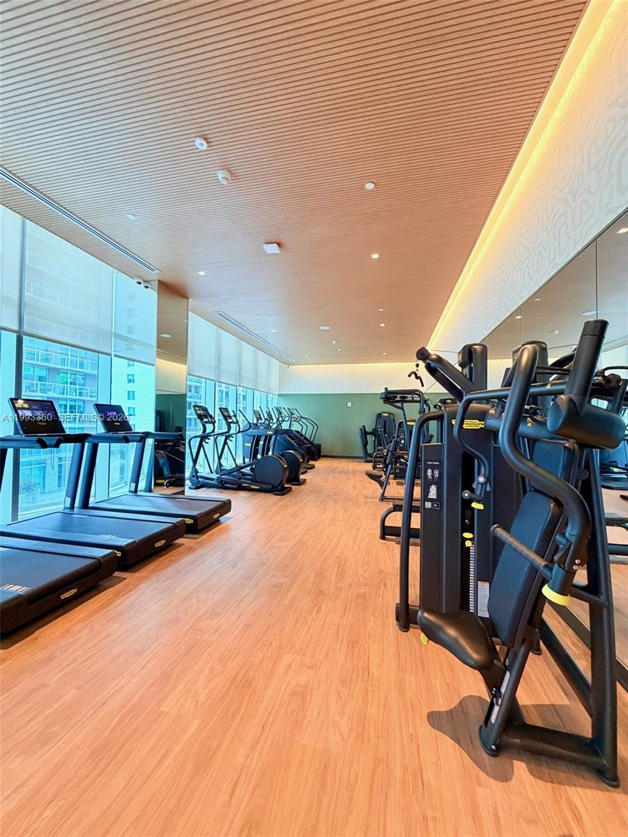 77 Southeast 5th Street, Unit 1608 Miami, FL 33131 - Photo 28 of 44 a view of a room with gym equipment