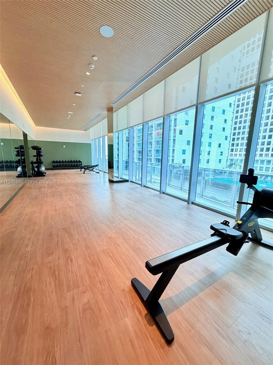 77 Southeast 5th Street, Unit 1608 Miami, FL 33131 - Photo 30 of 44 a view of a room with gym equipment